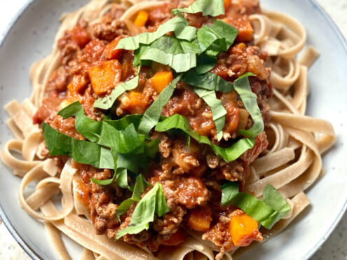 A plate of bolognese sauce served on zucchini noodles; another recipe to promote gut health.
