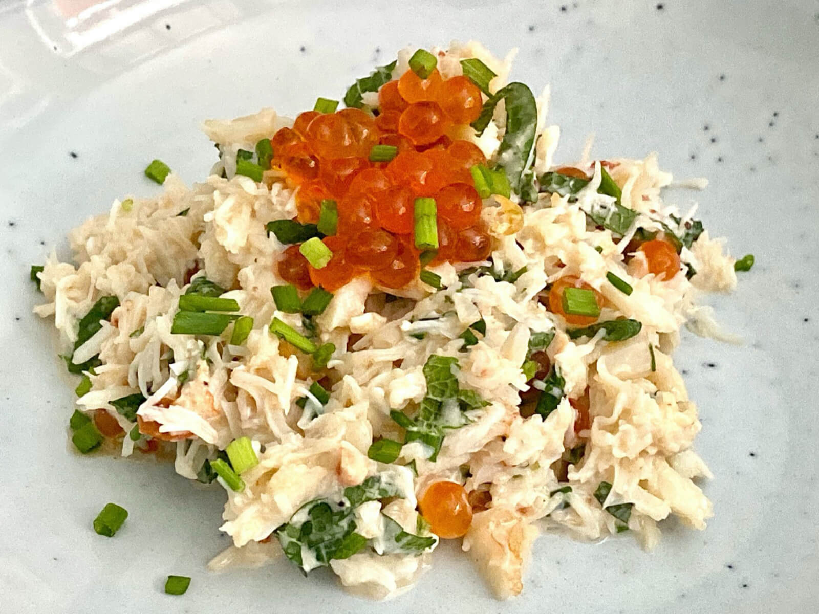 A layer of crab with salmon roe on top with herbs, which is really good for mental health.