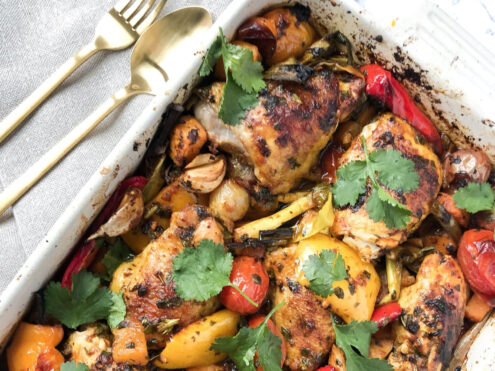 A tray of roasted chicken and vegetables with herbs - a recipe on the anti-inflammation diet and lifestyle.