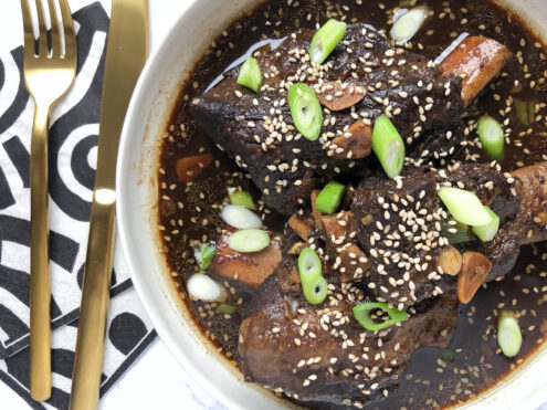 A close-up of a bowl of Korean Beef with chopped scallions on top