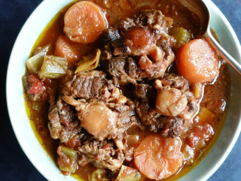 A slow cooker recipe with oxtail and carrots in a tomato sauce, created for easy digestion.