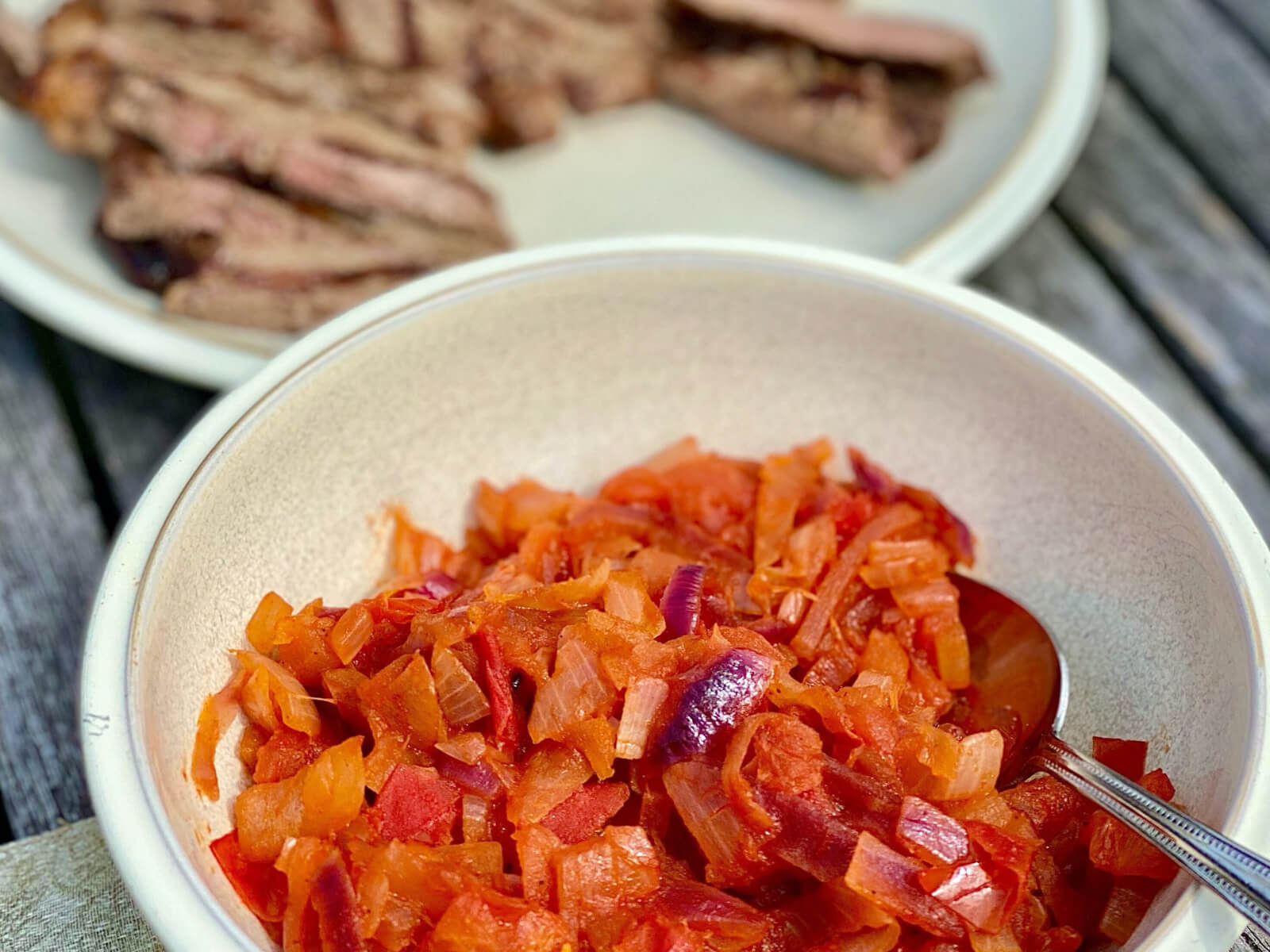 A dish of anti-inflammatory relish, consisting of tomatoes and onions.