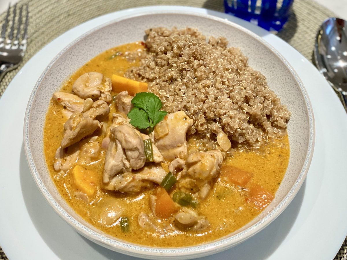 A plate of chicken curry made with red Thai paste and served with quinoa.