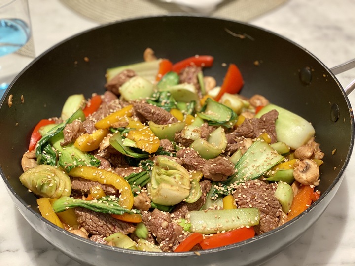 A pan of stir fried beef, peppers, bok choy and other ingredients for the recipe: Asian Beef Stir Fry.