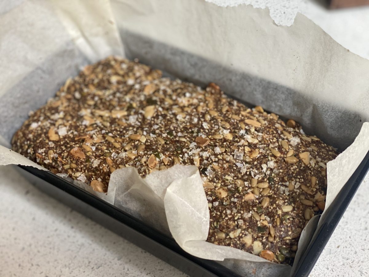 A loaf tin with seeded bread inside - a recipe for gut health.