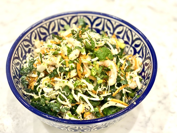A dish of salad with prawns and shredded veggies.