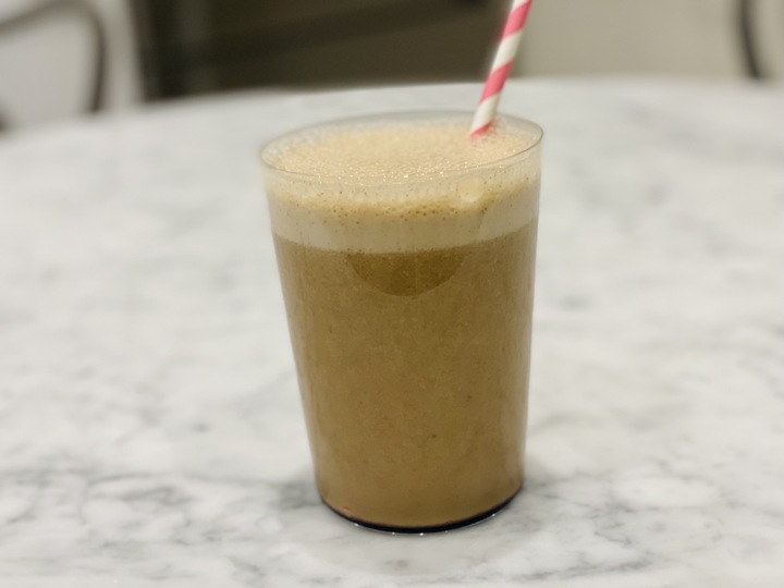 A glass of the healthiest Frappuccino with a red and white straw.