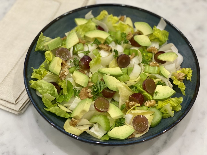 A bowl of Waldorf salad with grapes, walnuts and other superfoods, to complement a low-inflammation lifestyle.