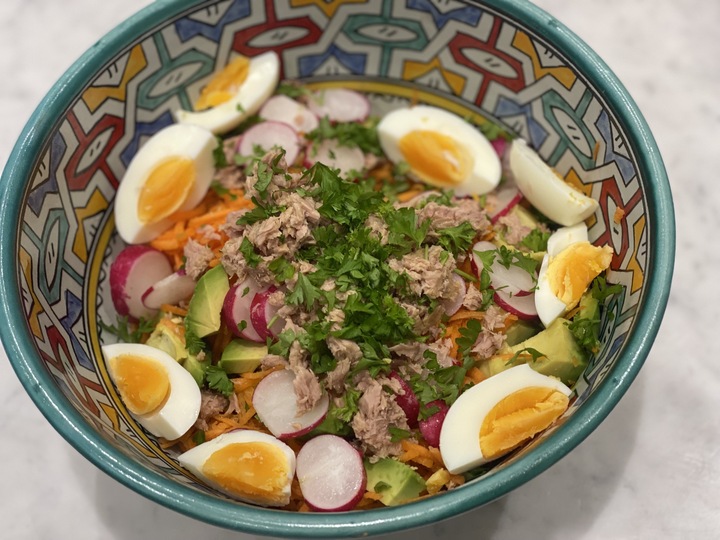 A colourful bowl of egg, carrot, tuna, radish, parsley and avocado salad, showing one of many recipes on a low-inflammation lifestyle plan.