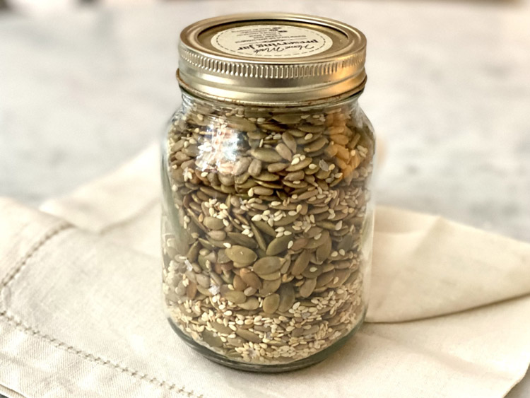 A jar of mixed seeds for healthy snacking.
