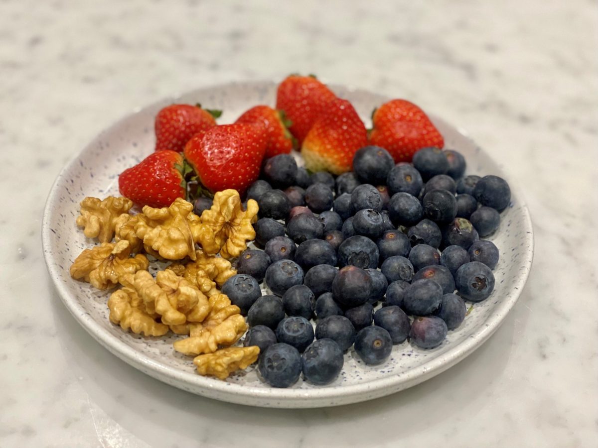 A Nutritious Snack Without Additives - A Plate of Walnuts and Berries.