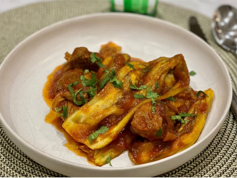 A dish of stew with eggplant and lamb for the Eat Burn Sleep Lifestyle.