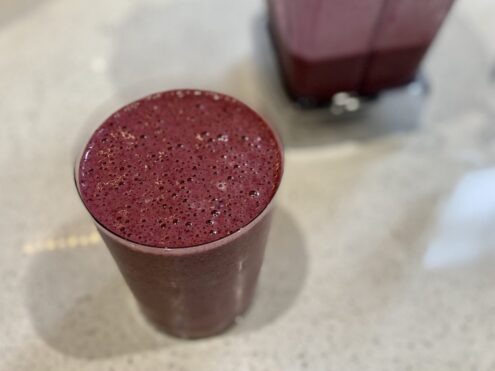 A cup of blended blueberry with other ingredients - anti-inflammatory shake.