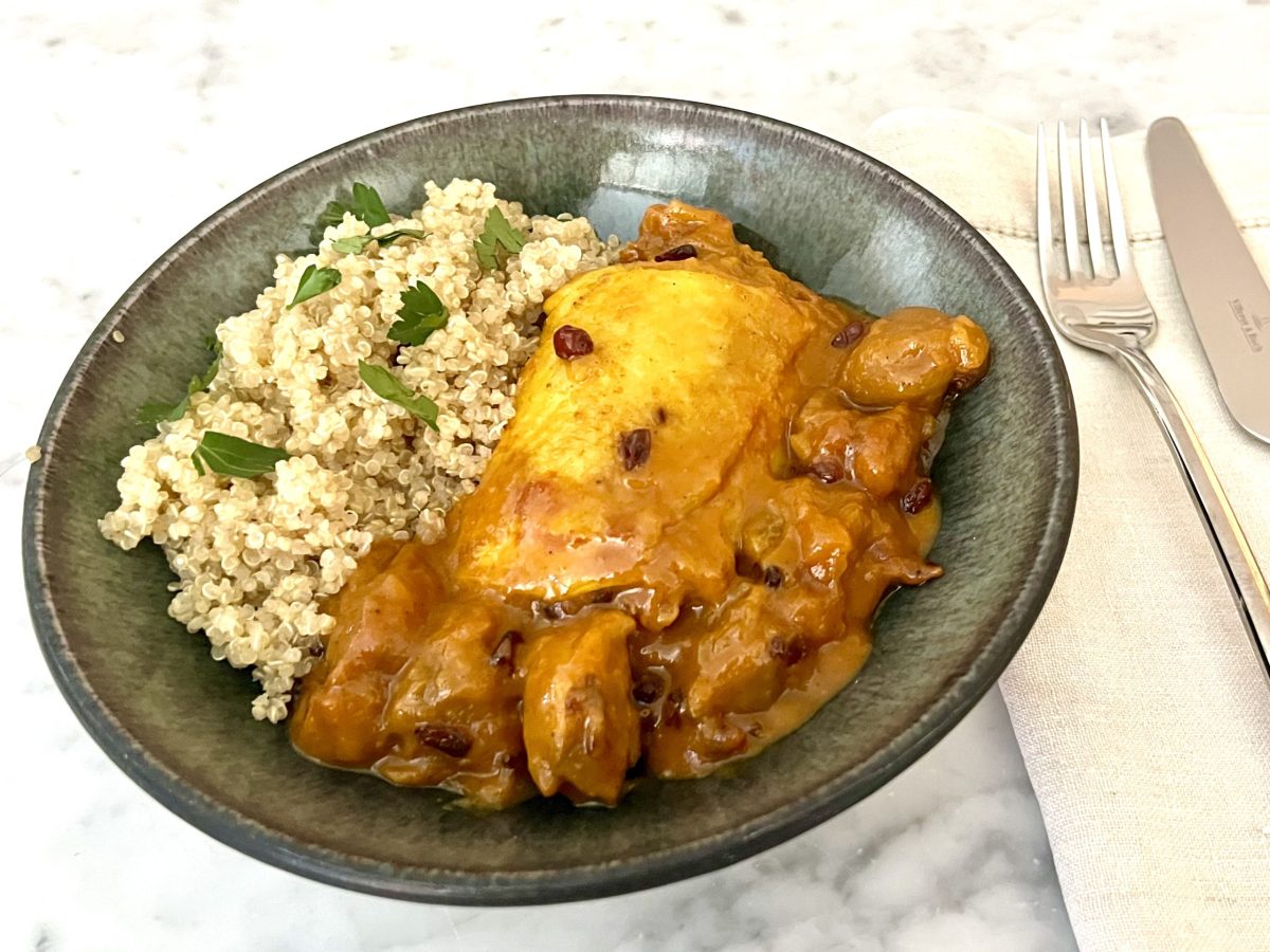 A bowl of Persian chicken stew with plums and cauliflower rice.