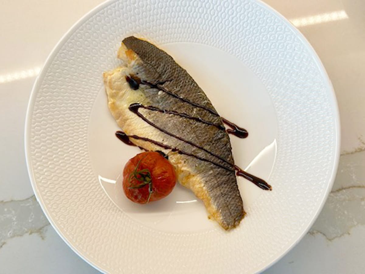 Sea bass with lemon, black pepper, tomatoe, and balsamic drizzle