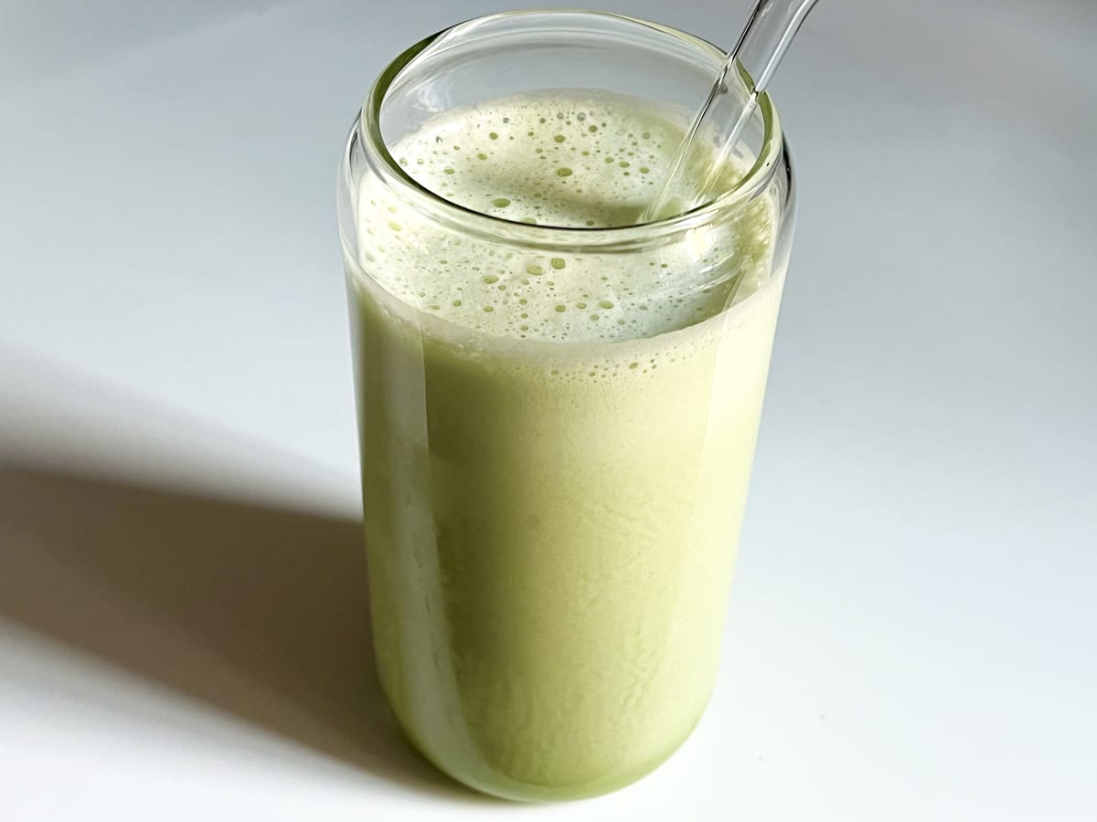 Collagen matcha iced latte in a glass with a straw