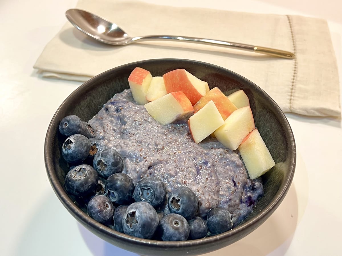 Protein Berries Porridge topped with blueberries and red apple cubes